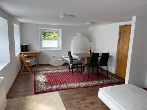 a living room with a table and chairs and a bathroom at Familienfreundliches Haus mit eingezäuntem Garten in Biberwier