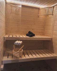 uma sauna com duas pessoas sentadas nela em L'Eden chambre d'hôtes avec jacuzzi et massages em Saint-Aubin-la-Plaine