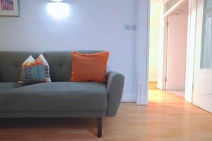 a couch with two pillows on it in a living room at Camden Serviced Apartments by Globe Apartments in London