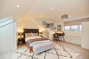 a bedroom with a bed and a desk in it at The Redbridge Sanctuary - Spacious 3BDR House with Garden in London