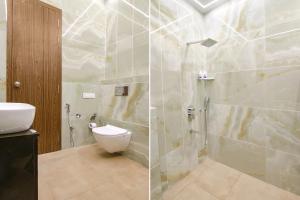 a bathroom with a shower and a toilet in it at FabHotel Prime Royal Court in Ludhiana