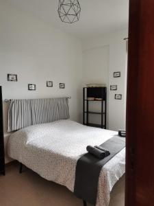 a bedroom with a bed with a pillow and a clock on the wall at Trapani Emotions apartment in Valderice
