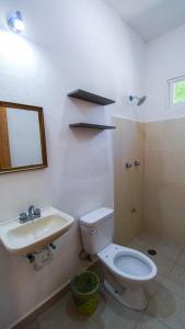 a bathroom with a toilet and a sink at Las Palmas in Bacalar