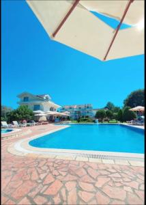 a view of a swimming pool in a resort at Hotel Comfort & Villas in Donji Štoj