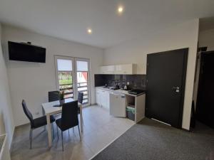 a kitchen with a table and chairs in a room at Willa Lawenda Apartament 2 in Rytro