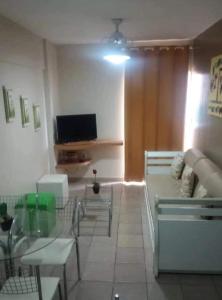 a living room with a couch and a tv at Splendor Thermas in Caldas Novas +9 photos