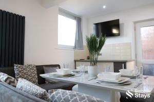 a living room with a table and a couch at Modern 2 Bed House With Driveway in Longton