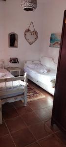 a bedroom with two beds and a heart sign on the wall at Golemi kamik Pirot in Pirot