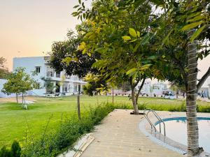 a park with a bench next to a tree at Shree Yog Maya Resort in Pushkar