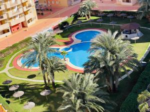 an overhead view of a resort pool with palm trees at Puerto Mar Fase I - Atico in La Manga del Mar Menor