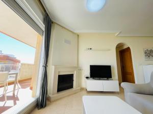 a living room with a tv and a fireplace at Puerto Mar Fase I - Atico in La Manga del Mar Menor