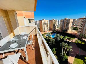a balcony with a table and chairs and a view of a city at Puerto Mar Fase I - Atico in La Manga del Mar Menor