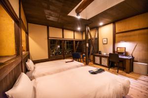 Katil atau katil-katil dalam bilik di NIPPONIA HOTEL Ozu Castle Town
