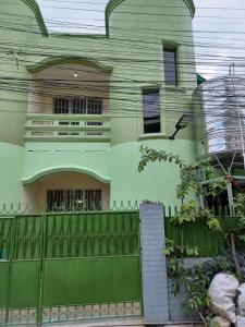 a green house with a fence in front of it at Cebu City 80sq Apartment near SM Seaside NuStar Ocean Park Dynamic Herb in San Roque