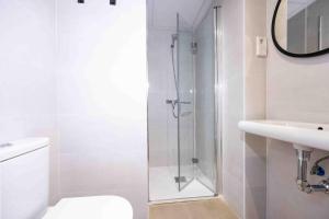 a bathroom with a shower and a toilet and a sink at Apartamentos turísticos Plaza Sevillano , by CartagenaSpain in Cartagena +31 photos