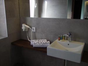 a bathroom with a white sink and a mirror at Villa iacca in Jaca