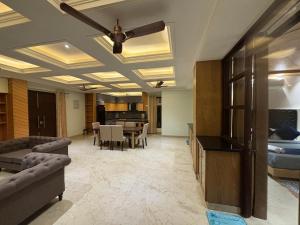a living room with a ceiling fan and a dining room at 4 BHK Mountain View Villa In Rishikesh in Rishīkesh