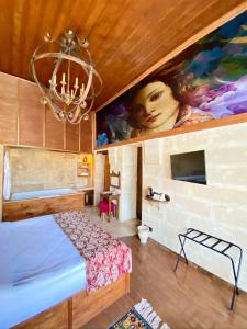 a bedroom with a bed and a painting on the wall at YOHANNES Stone Cappadocia in Ürgüp