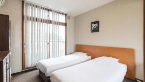 Voodi või voodid majutusasutuse Tabist International Hotel Kaike toas
