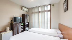 Voodi või voodid majutusasutuse Tabist International Hotel Kaike toas