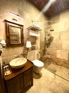 a bathroom with a sink and a toilet and a shower at YOHANNES Stone Cappadocia in Ürgüp +18 photos