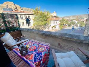 a balcony with a table and chairs on a balcony at YOHANNES Stone Cappadocia in Ürgüp
