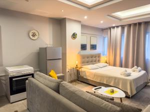 a living room with a bed and a couch at Glamorous & Spacious Renovated Apartment, Syntagma, DT Athens in Athens