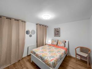 a bedroom with a bed and a chair in it at DARETSOLUTION in Essômes-sur-Marne