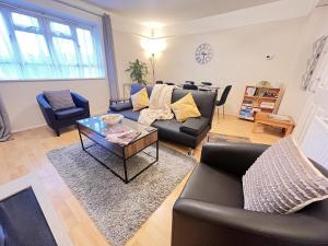 a living room with a couch and a table at Glazebrook in London