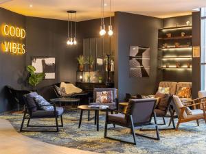 a lobby with chairs and tables in a store at Novotel Edinburgh Centre in Edinburgh