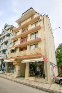 a tall building on a street with a store front at Feel at Home in Sandanski