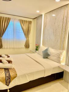 een slaapkamer met een groot bed en een raam bij Pattaya Pool Villa39A 300 mater to beach gate exit in Pattaya South