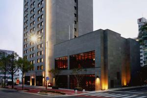 a building on a city street with a building at Ramada by Wyndham Gunsan in Gunsan