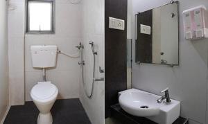 a bathroom with a white toilet and a sink at FabExpress Prabhu Sharan in Mumbai