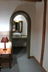 a bathroom with a sink and a mirror at Wild Waves Surf-House in Popoyo