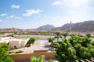 a view of the desert with mountains in the background at Radisson Blu Resort, Fujairah in Dibba