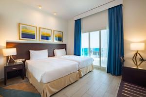 Uma cama ou camas num quarto em Radisson Blu Resort, Fujairah