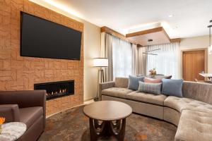 a living room with a couch and a fireplace at Casitas At The Hoodoo Moab, Curio Collection By Hilton in Moab