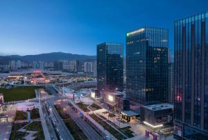 an overhead view of a city with tall buildings at Wyndham Garden Lanzhou West Railway Station in Lanzhou