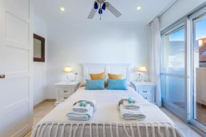 una camera da letto con un grande letto con asciugamani di 797 HOLIDAY RENTALS- Renovado piso en el paseo maritimo fuengirola a Fuengirola