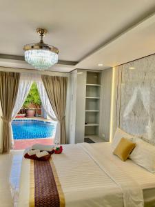 a bedroom with a bed and a swimming pool at Pattaya Pool Villa39A 300 mater to beach gate exit in Pattaya South