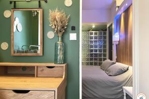 a bedroom with a mirror and a vase with flowers at Bienvenue au Chillou - Parking - Terrasse in Le Havre