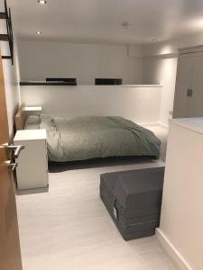 a bedroom with a bed and a table in it at Lovely Cozy One bedroom close to city centre Liverpool in Liverpool