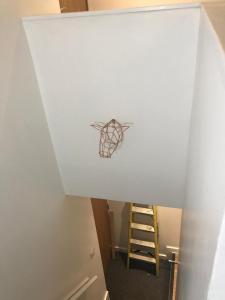 a room with a ladder and a drawing on the wall at Lovely Cozy One bedroom close to city centre Liverpool in Liverpool