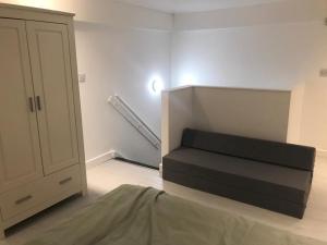 a room with a bed and a staircase in it at Lovely Cozy One bedroom close to city centre Liverpool in Liverpool