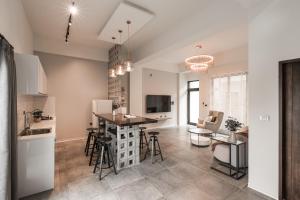 a kitchen and living room with a table and chairs at Vivir House in Hengchun South Gate