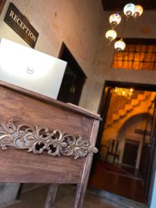 a wooden bench in front of a door with a sign at YOHANNES Stone Cappadocia in Ürgüp