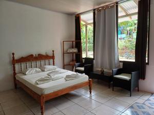 a bedroom with a bed and two chairs and a window at Mirians Place Drake in Drake