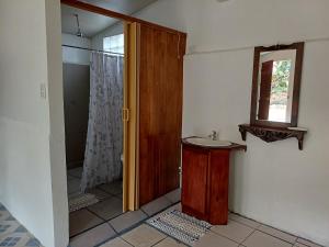 a bathroom with a sink and a wooden door at Mirians Place Drake in Drake