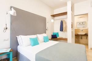a bedroom with a large bed and a bathroom at Boutique Suites 186 in Sorrento